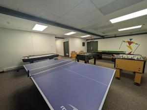 a ping pong room with ping pong tables at Rocky Mountain Condos by StayIn in Kimberley