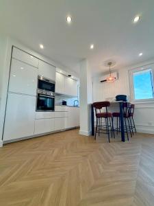 a kitchen and dining room with a table and chairs at Appartement avec jardin - Front de mer St Laurent-du-Var in Saint-Laurent-du-Var