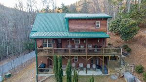 an aerial view of a log cabin with a green roof at Bear Creek in Sugar Grove