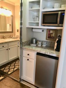 a kitchen with white cabinets and a stainless steel refrigerator at Elegant Napa Escape Walk to Wineries & Dining in Vichy Springs
