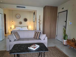 a living room with a couch and a bed at Rastoni Studio Xylokastro 2 in Melission +7 photos
