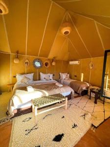 a bedroom with a bed in a tent at Anssuf merzouga luxury camp in Merzouga