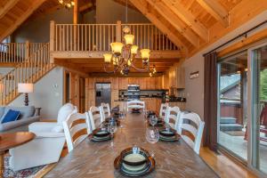 a dining room with a long table and white chairs at Mayapple Ridge in Sugar Grove