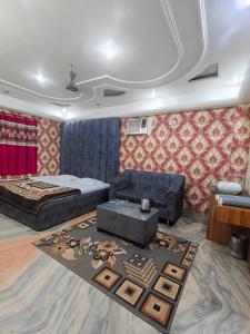 a living room with a bed and a couch at Hotel Parinay Vatika - Deoghar in Deoghar