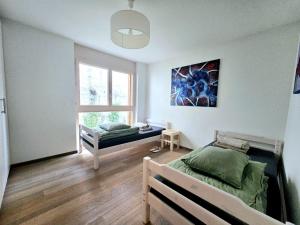 a bedroom with two beds and a window at Champex Art Lodge in Orsières +40 photos