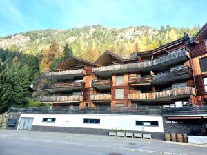 a building with balconies on the side of a street at Champex Art Lodge in Orsières