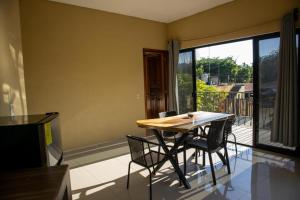 a table and chairs in a room with a balcony at Vista Sayulita in Sayulita