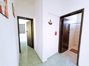 a hallway with two doors and a mirror at Casa Jedidian in El Cuyo +2 photos