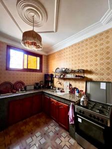 a kitchen with a stove and a counter top at Dar Zina in Aourir