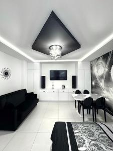 a living room with a black couch and a table at Apartament Pegaz in Gniezno