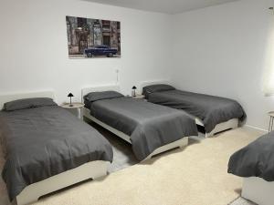 a bedroom with two beds and a car on the wall at Home15 Kassel in Kassel