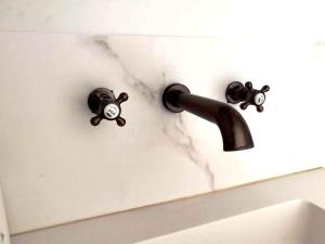 a bathroom sink with a faucet with a monkey holder at Casa Rural Lorehonea in Artariáin