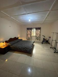 a bedroom with a bed in the middle of a room at Brimelia Lodge 