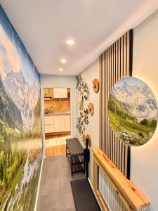 a home hallway with a mural of mountains at Ferienwohnung im Usseltal - Zirben Spa - Monheimer Alb - Altmühltal - Familie Geyer Daiting in Monheim