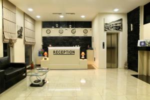 a lobby with a reception sign in a store at Hotel Gureli in Tbilisi City
