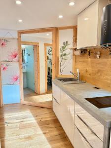 a kitchen with a sink and a door into a room at Ferienwohnung im Usseltal - Zirben Spa - Monheimer Alb - Altmühltal - Familie Geyer Daiting in Monheim