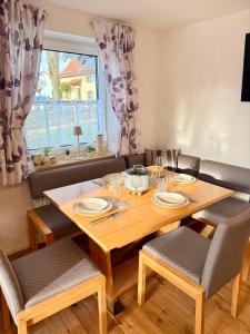 a dining room with a wooden table and chairs at Ferienwohnung im Usseltal - Zirben Spa - Monheimer Alb - Altmühltal - Familie Geyer Daiting in Monheim