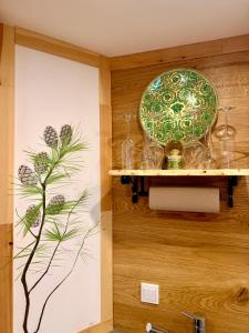 a wall with a plate and glasses on a shelf at Ferienwohnung im Usseltal - Zirben Spa - Monheimer Alb - Altmühltal - Familie Geyer Daiting in Monheim +97 photos