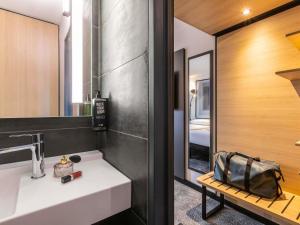 a bathroom with a white sink and a mirror at ibis Nancy Centre Stanislas in Nancy +42 photos