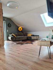 a living room with a couch and a table at Studiowohnung für 2 DG in Schwedelbach