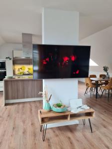 a living room with a large tv on a wall at Studiowohnung für 2 DG in Schwedelbach