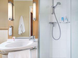a bathroom with a sink and a shower at ibis Nantes Centre Tour Bretagne in Nantes +49 photos