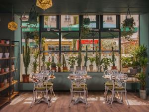 a room with tables and chairs and potted plants at ibis Paris Bastille Opera in Paris