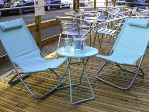 two blue chairs and a table on a patio at ibis Nantes Centre Tour Bretagne in Nantes