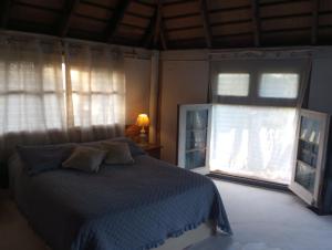 a bedroom with a bed and two windows at Morocha in Estación Costa Azul