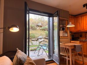 a kitchen with a sliding glass door to a patio at Confort nórdico en la montaña - Besiberri 4 in Pla de l'Ermita