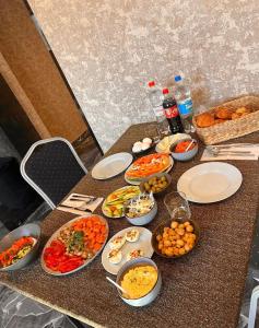 a table topped with plates and bowls of food at Or Haganuz in Dobrovelychkivka