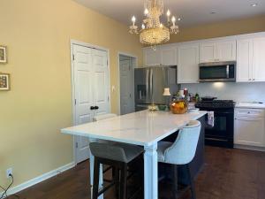 a kitchen with a white counter top and a table at Suite in Lakeside house in Alpharetta +10 photos