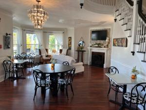 a living room with a table and chairs and a couch at The Inn At The Bridge in Northville