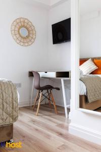 a bedroom with a desk and a bed and a chair at The residency rooms walton in Walton on the Hill