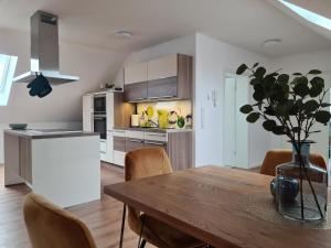 a kitchen and dining room with a table and chairs at Studiowohnung für 2 DG in Schwedelbach