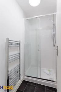a shower with a glass door in a bathroom at The residency rooms walton in Walton on the Hill