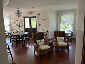 a living room with a dining room table and chairs at The Inn At The Bridge in Northville