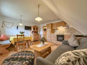 a living room with a couch and a table at Blumenhof II in Dietersdorf