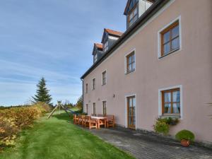 a house with a picnic table and a playground at Blumenhof II in Dietersdorf
