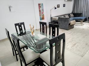 a glass table and chairs in a living room at 3 bedrooms apartment in Al Rehab city in New cairo