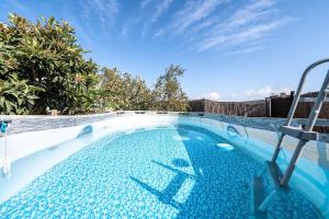 a large swimming pool with a blue sky in the background at El Refugio de la Caridad in Tenteniguada