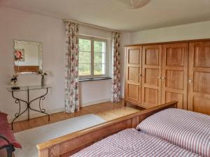 a bedroom with a bed and a desk and a window at Schwermann in Schmallenberg
