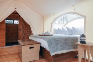 a bedroom with a bed in a tent at Under Canvas Yosemite in Groveland