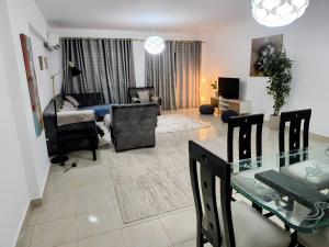 a living room with a table and a dining room at 3 bedrooms apartment in Al Rehab city in New cairo