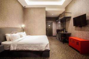 a bedroom with a bed and a flat screen tv at Fhandika Boutique Inc. in Geutieue +19 photos