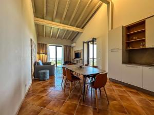 a kitchen and dining room with a table and chairs at Castello Belvedere Apartments in Desenzano del Garda