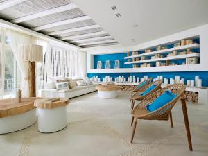 a living room with blue walls and chairs at Artemis Seaside Resort in Paliochori