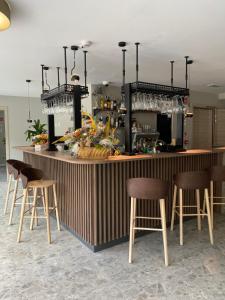 a bar with four stools and a counter with a bar at Maison Poluc - Chiaro di Luna in Champoluc