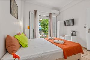 a bedroom with a large white bed with an orange blanket at SALV3R Hotel in Athens +68 photos