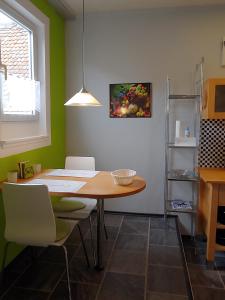 a dining room with a table and two chairs at Holiday il Macellaio - NW Zentrum - X-MAS Markt 5min entfernt in Neustadt an der Weinstraße